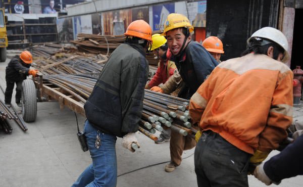 2008 年 1 月 17 日,中国建筑工人在上海一处建筑工地准备钢筋。