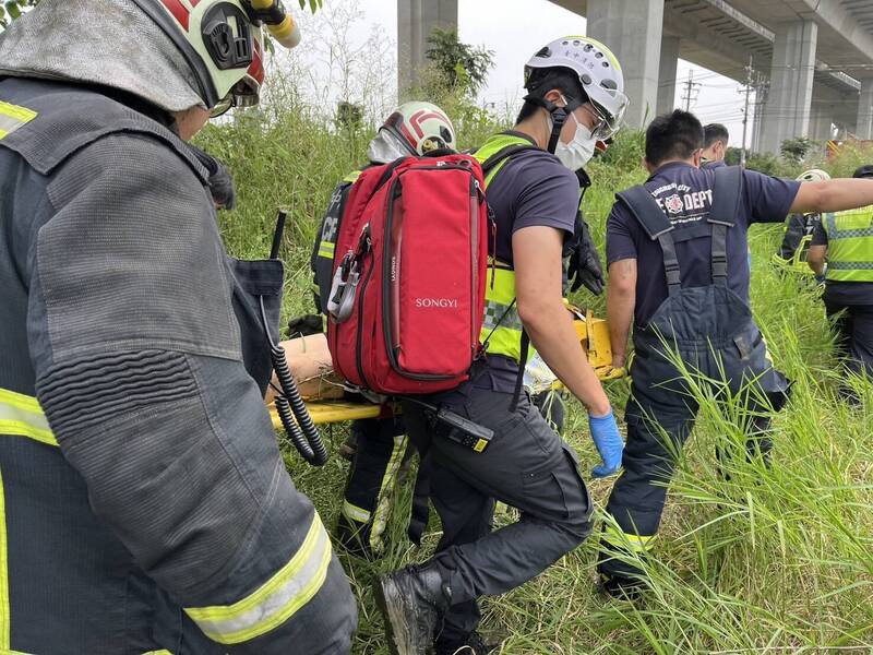 消防人员将跳桥的女子抬上担架送医。（民众提供）