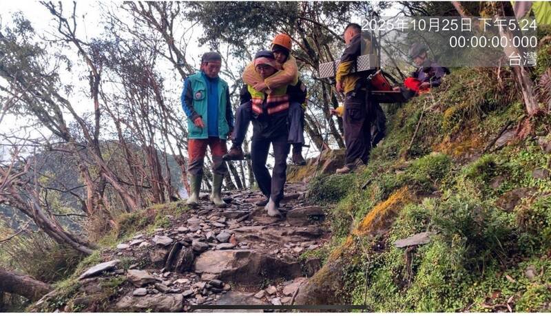 警消人员接力将彭女从玉山登山步道背负下山。（图由警方提供）